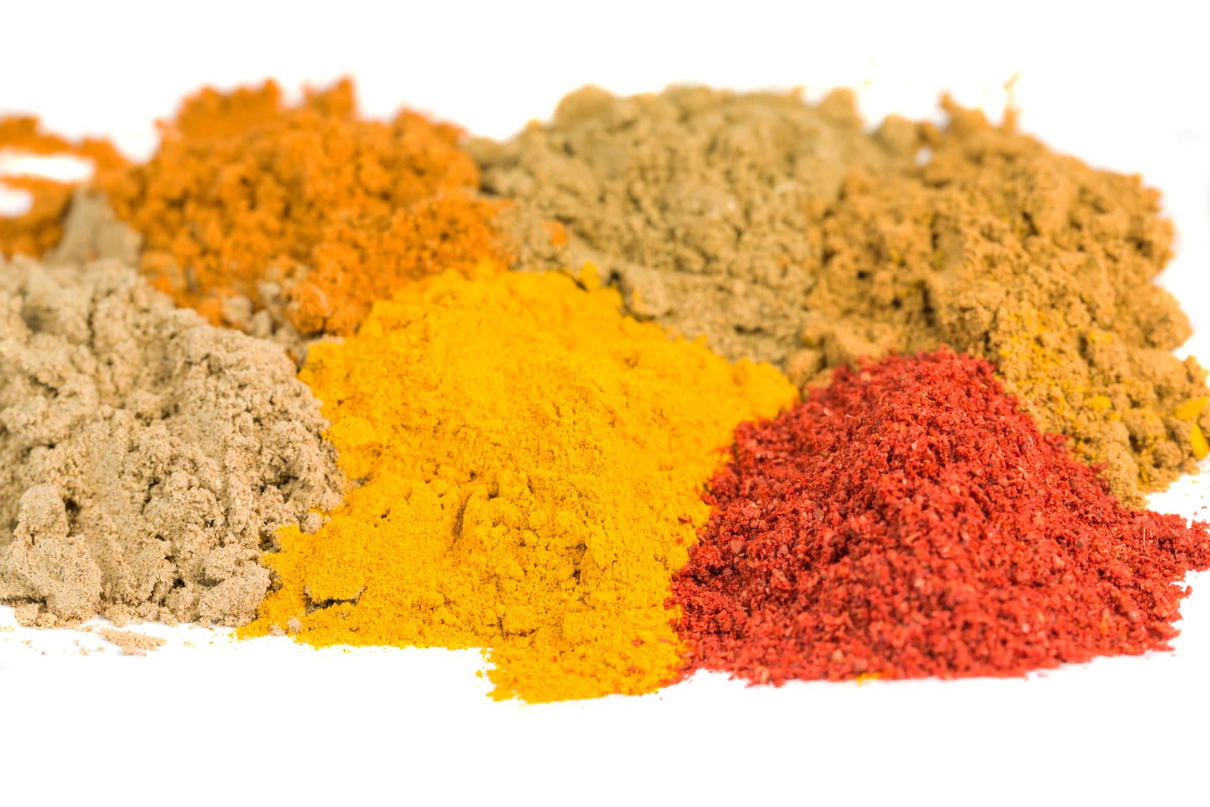 Various powdered spices over white background Alland & Robert